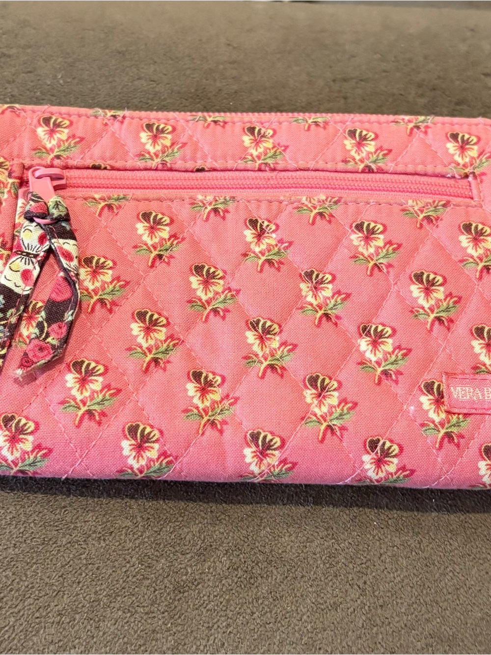 Vera Bradley Pink Quilted Floral Zip  wallet . Has a small tear on the inside